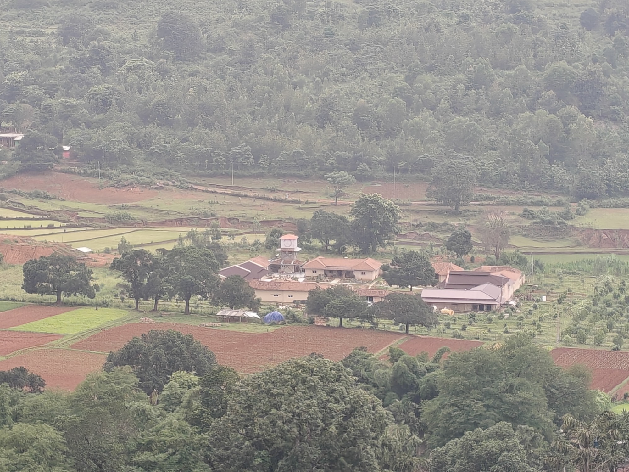 The Satori Valley campus seen across the fields, with the clock tower at its centre
